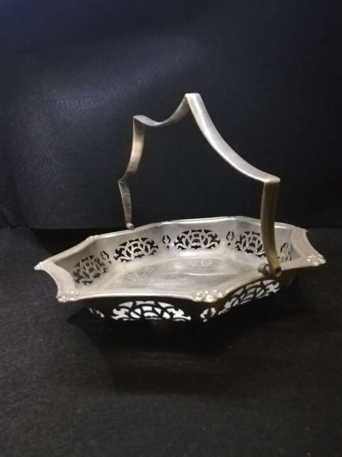 Ornate metal bowl with handle and feet