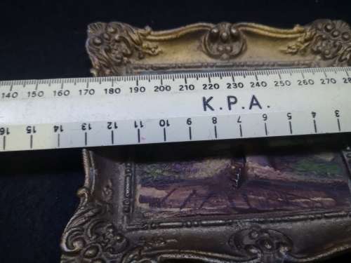 Cast metal frame and painting