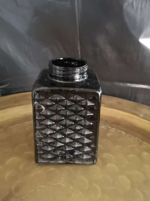 Black milk glass bottle