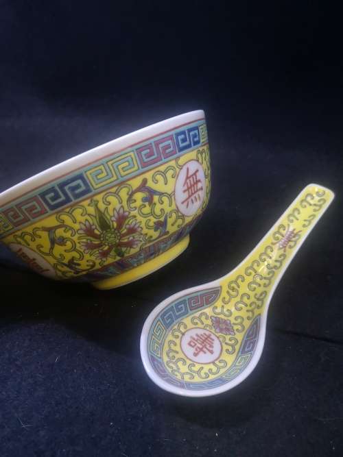 Yellow Chinese porcelain bowl and spoon