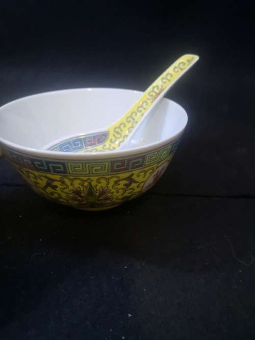 Yellow Chinese porcelain bowl and spoon