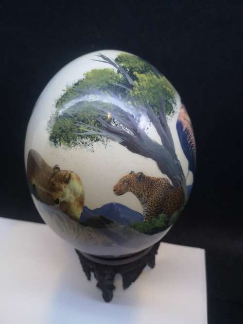 Hand painted Ostrich egg on carved wooden bottom