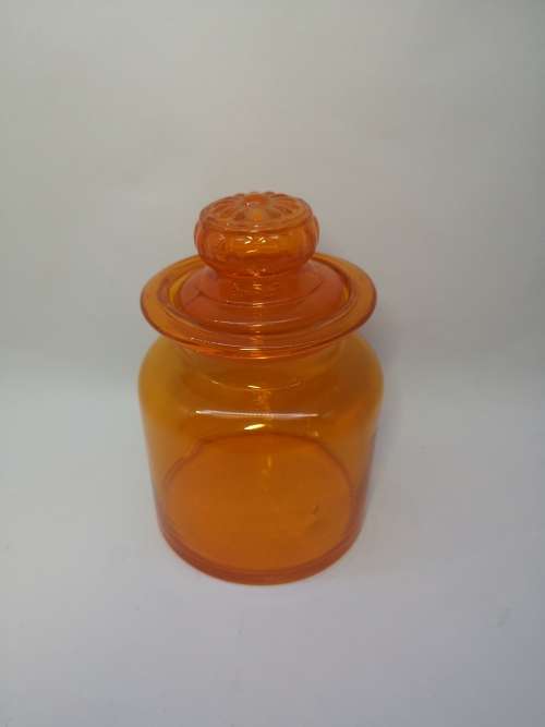 Small Bright orange glass bottle and glass lid