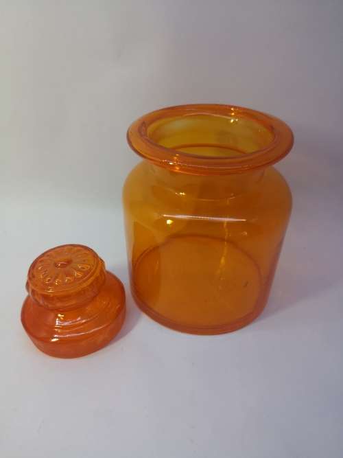 Small Bright orange glass bottle and glass lid