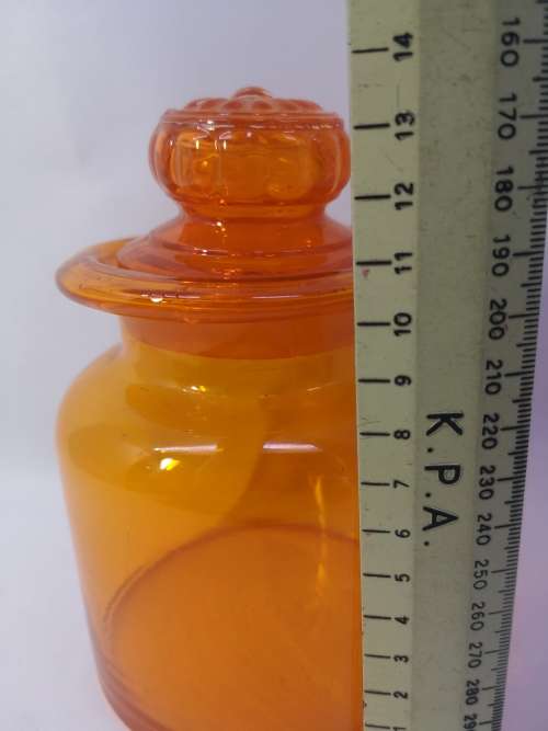 Small Bright orange glass bottle and glass lid