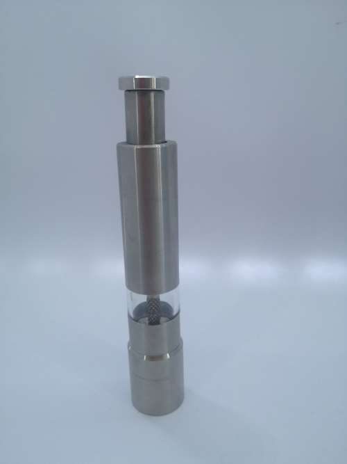 Pump action salt or pepper grinder