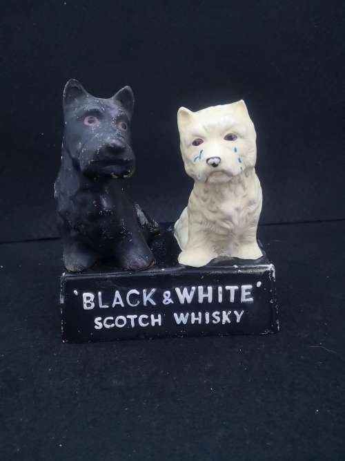 Old and damaged Black & Shite Scotch Whisky Scotty dogs