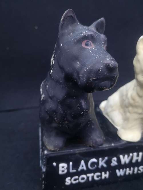 Old and damaged Black & Shite Scotch Whisky Scotty dogs