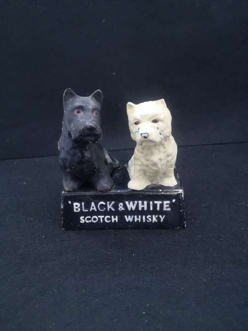 Old and damaged Black & Shite Scotch Whisky Scotty dogs