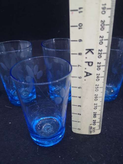 Turquoise liquor/shot glasses - one has two fleabites