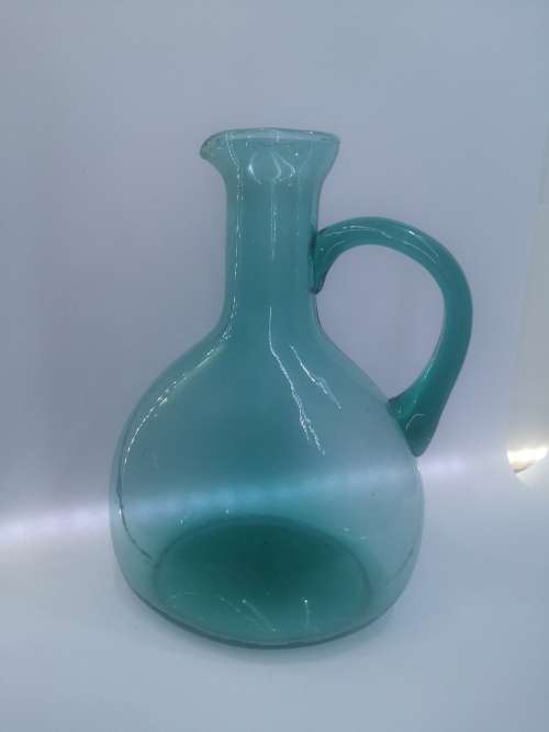 Turquoise blue glass bottle - it has a crack just above the handle - but beautiful!