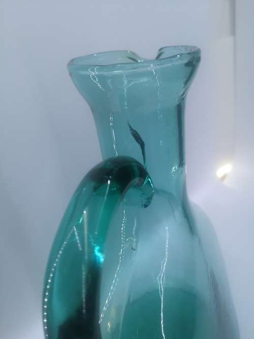 Turquoise blue glass bottle - it has a crack just above the handle - but beautiful!