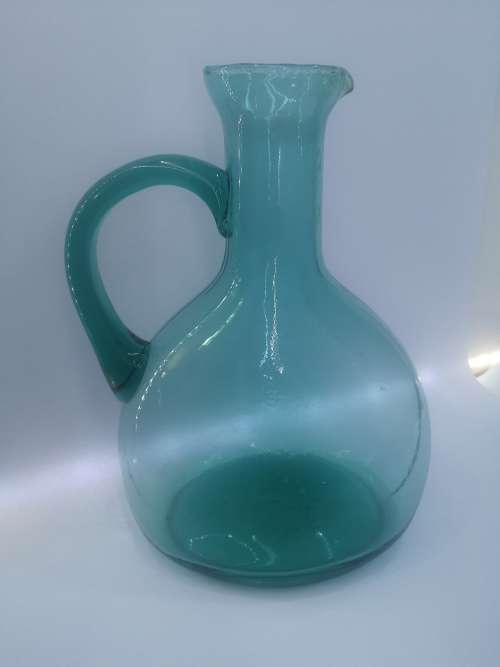 Turquoise blue glass bottle - it has a crack just above the handle - but beautiful!