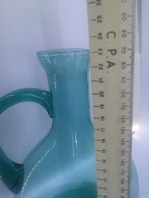 Turquoise blue glass bottle - it has a crack just above the handle - but beautiful!