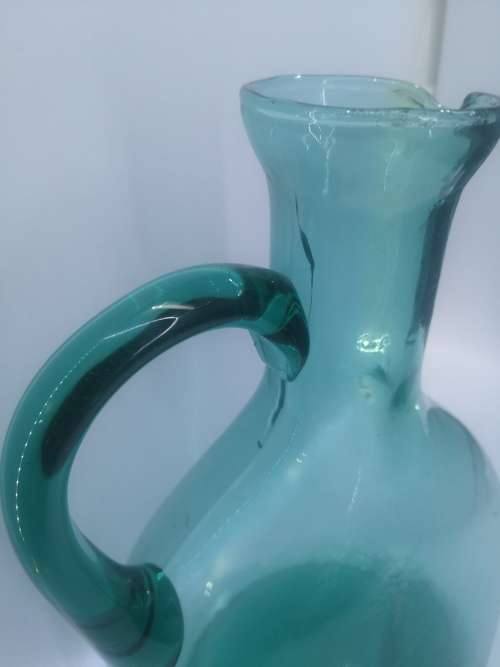 Turquoise blue glass bottle - it has a crack just above the handle - but beautiful!