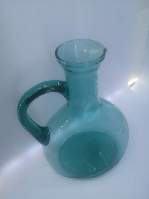 Turquoise blue glass bottle - it has a crack just above the handle - but beautiful!