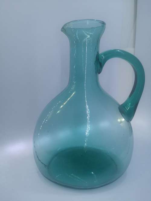 Turquoise blue glass bottle - it has a crack just above the handle - but beautiful!