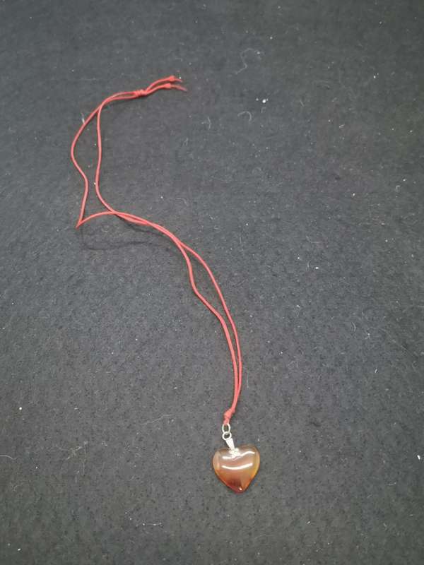 Semi-precious stone heart pendant on a string