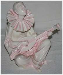 A RESIN IVORY CLOWN PLAYING THE BANJO