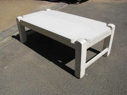 A VINTAGE COFFEE TABLE PAINTED WHITE