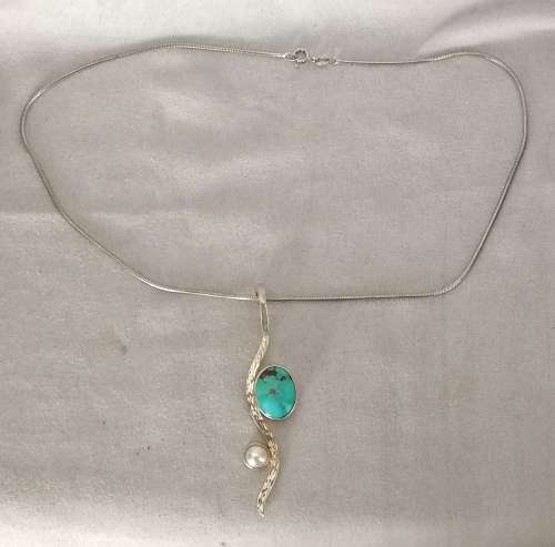 A stunning navajo 950 silver turquoise and mabe pendant