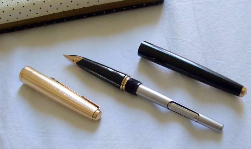 Vintage Boxed Black & Rolled Gold Parker 65 Pen in good working condition.