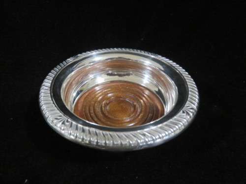 Antique silver plate and wood wine bottle coaster.