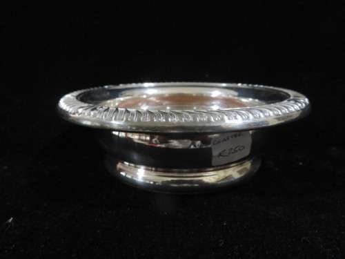 Antique silver plate and wood wine bottle coaster.