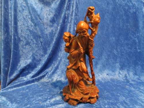 Carved wooden oriental figurine