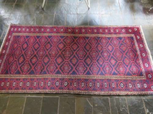 A Persian hand knotted Beluchi rug