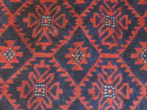 A Persian hand knotted Beluchi rug