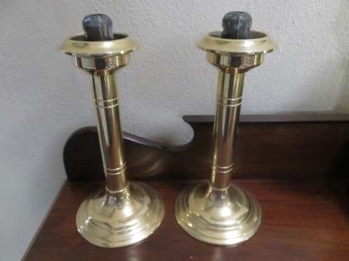 Pair of brass spring loaded candlesticks