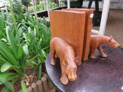 Pair of large wooden bookends with leopards