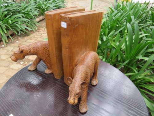 Pair of large wooden bookends with leopards