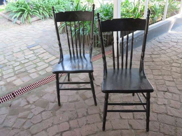 A pair of early 20th century carved oak spindle-back chairs.