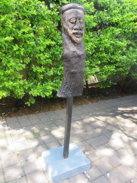 Carved wooden African bust on stand