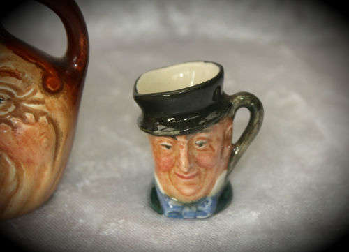 2 small Royal Doulton character jugs -John Barleycorn and Mr Micawber- 1 small paint chip