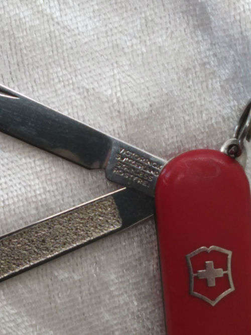 Vintage Victorinox Swiss  pocket knife with sheath - see condition piece of cover chipped off