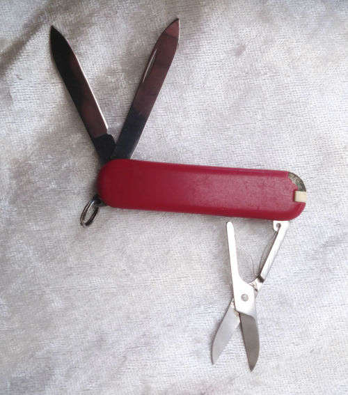 Vintage Victorinox Swiss  pocket knife with sheath - see condition piece of cover chipped off