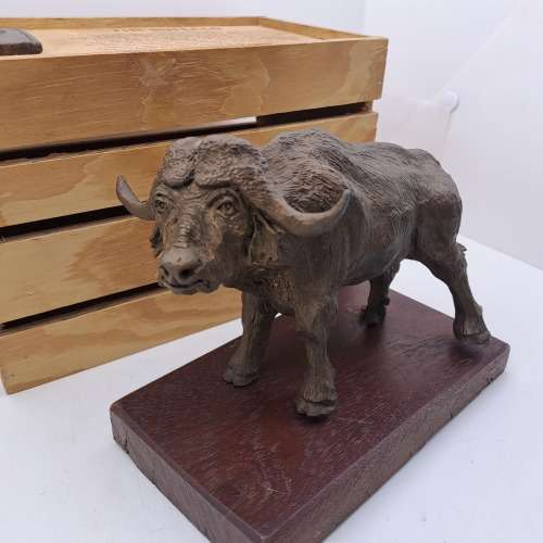 a Buffalo Figurine (Hand Made) in wooden Crate -ONE FOOT/HOOF BROKEN