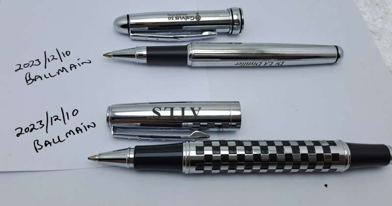 2 Pre-owned Balmain Ballpoint Pens -Boxed- Branded and one engraved -Ink is ok