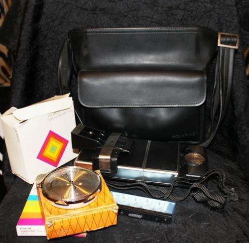 An old Polaroid Camera with bag,Thermometer ,film ,Tripod Grip (NOT TESTED) - please see all photo's