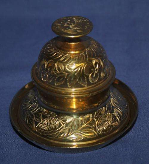 a Brass India  Bell in Holder on tray 185g - 68mm