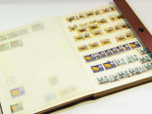 Album with about 100 old Rhodesian / Zimbabwe stamps - as per photo