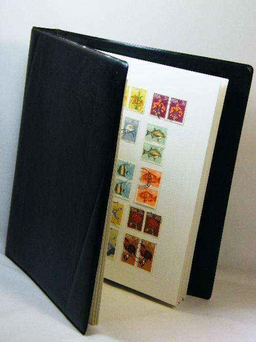 Stamp album with more than 300 South African stamps - many extra pages - as per photo