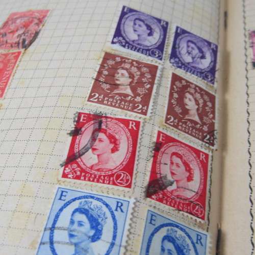 Old stamp album with over 300 stamps - some loose