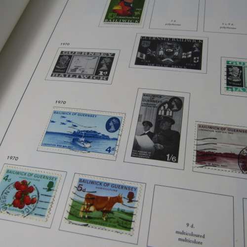 Guernsey and Jersey stamp album with hundreds of old stamps