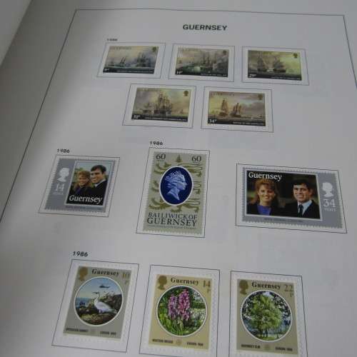 Guernsey and Jersey stamp album with hundreds of old stamps