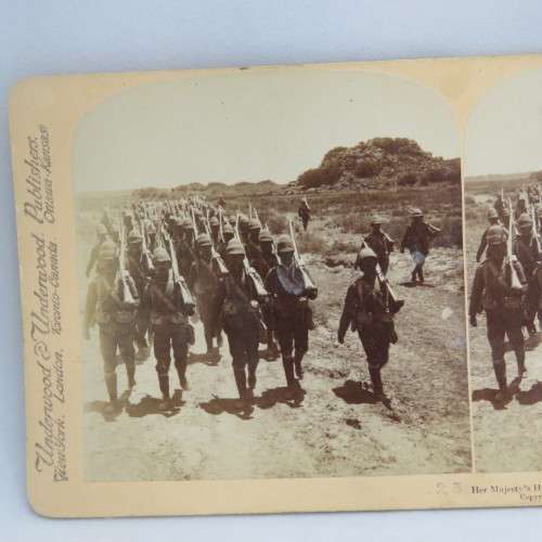 Boer War stereoscope card #25 - Her Majesty`s Heroes marching into Colesberg after the Boers retreat