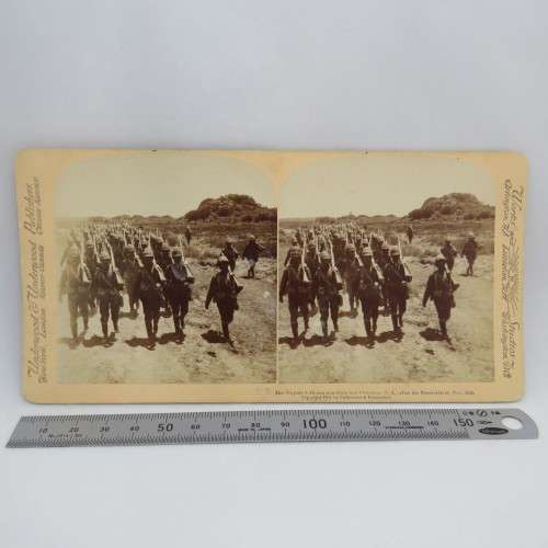 Boer War stereoscope card #25 - Her Majesty`s Heroes marching into Colesberg after the Boers retreat